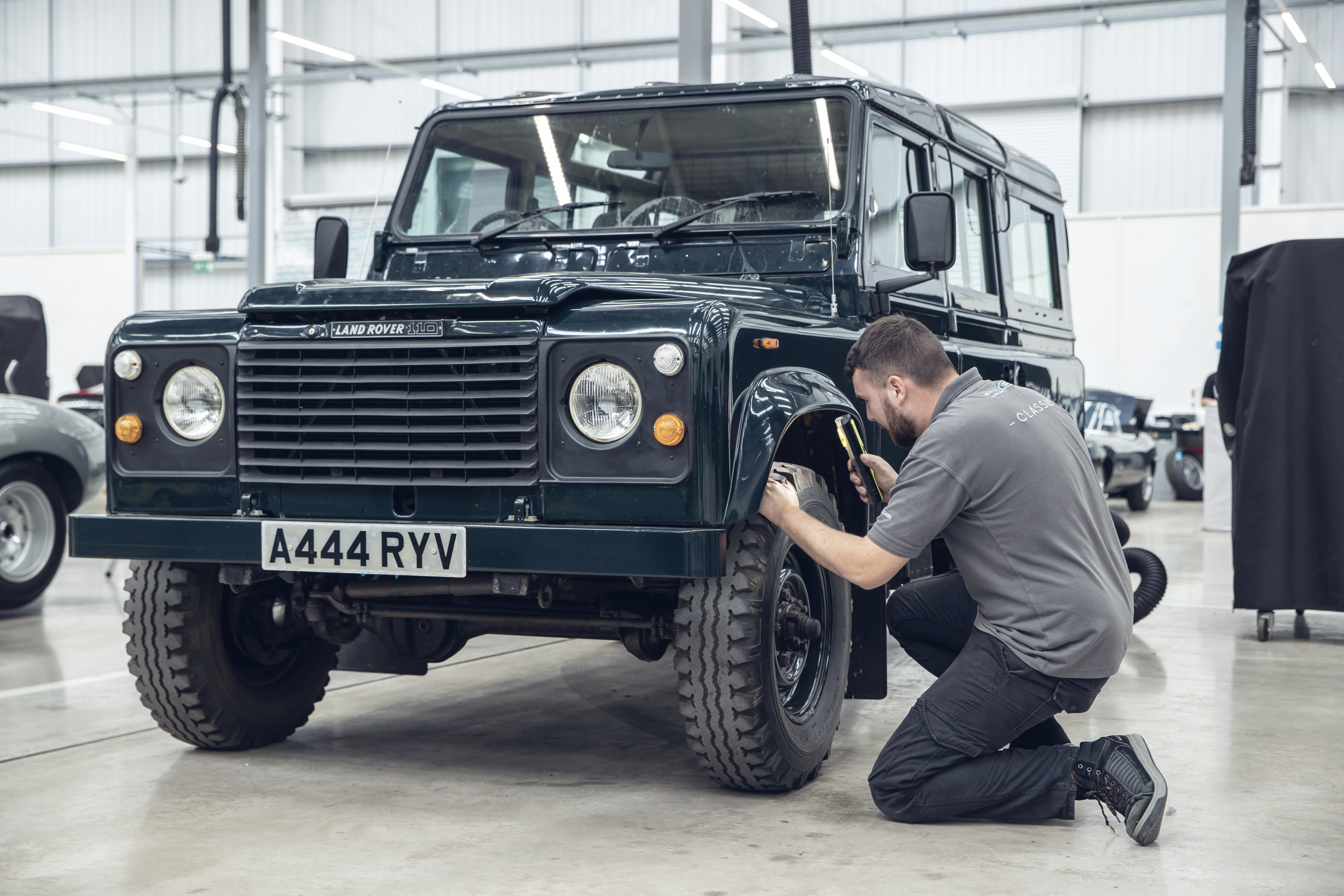 Man fixing Land Rover car