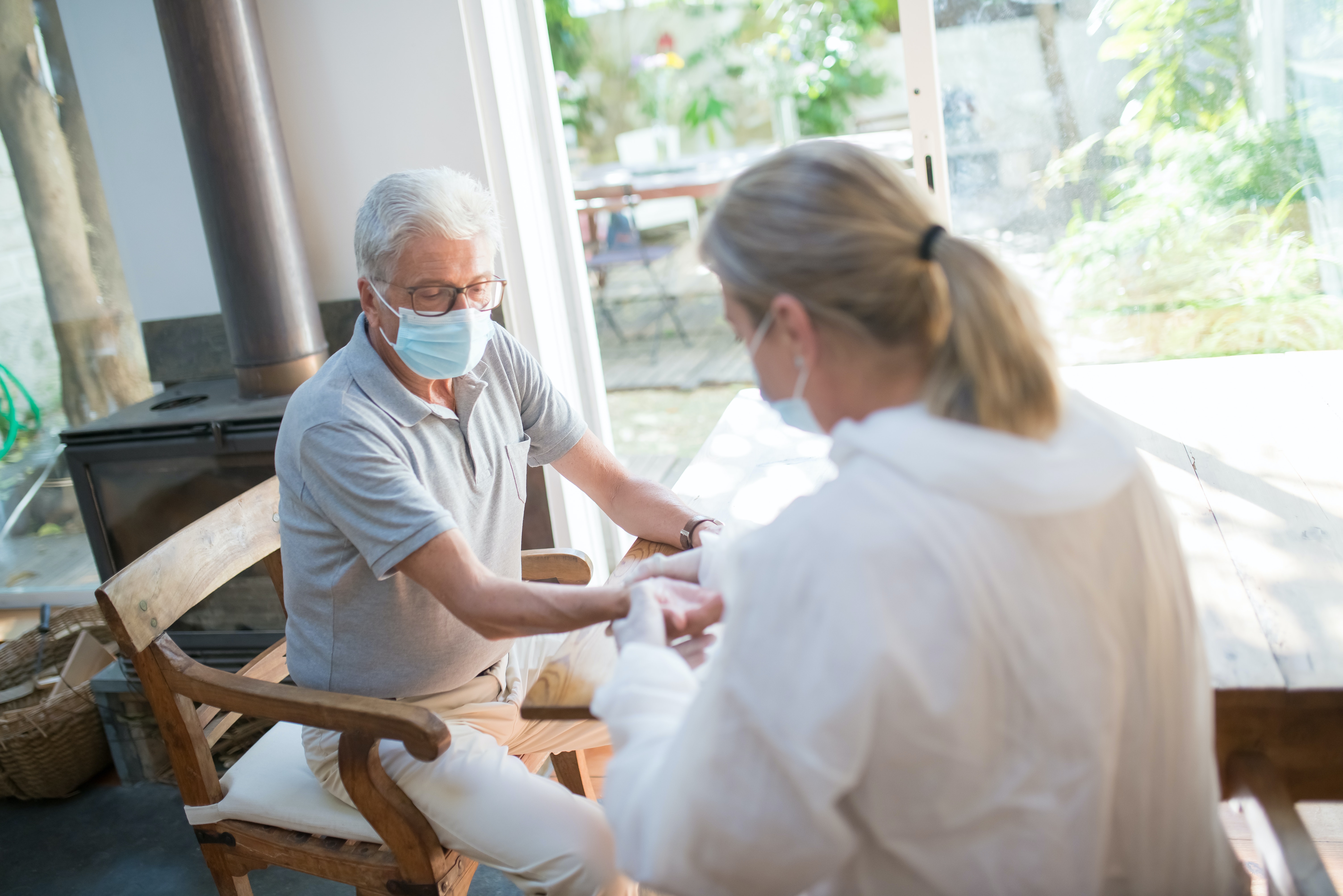 Doctor doing a Medical Examination on an Elderly Man at Home