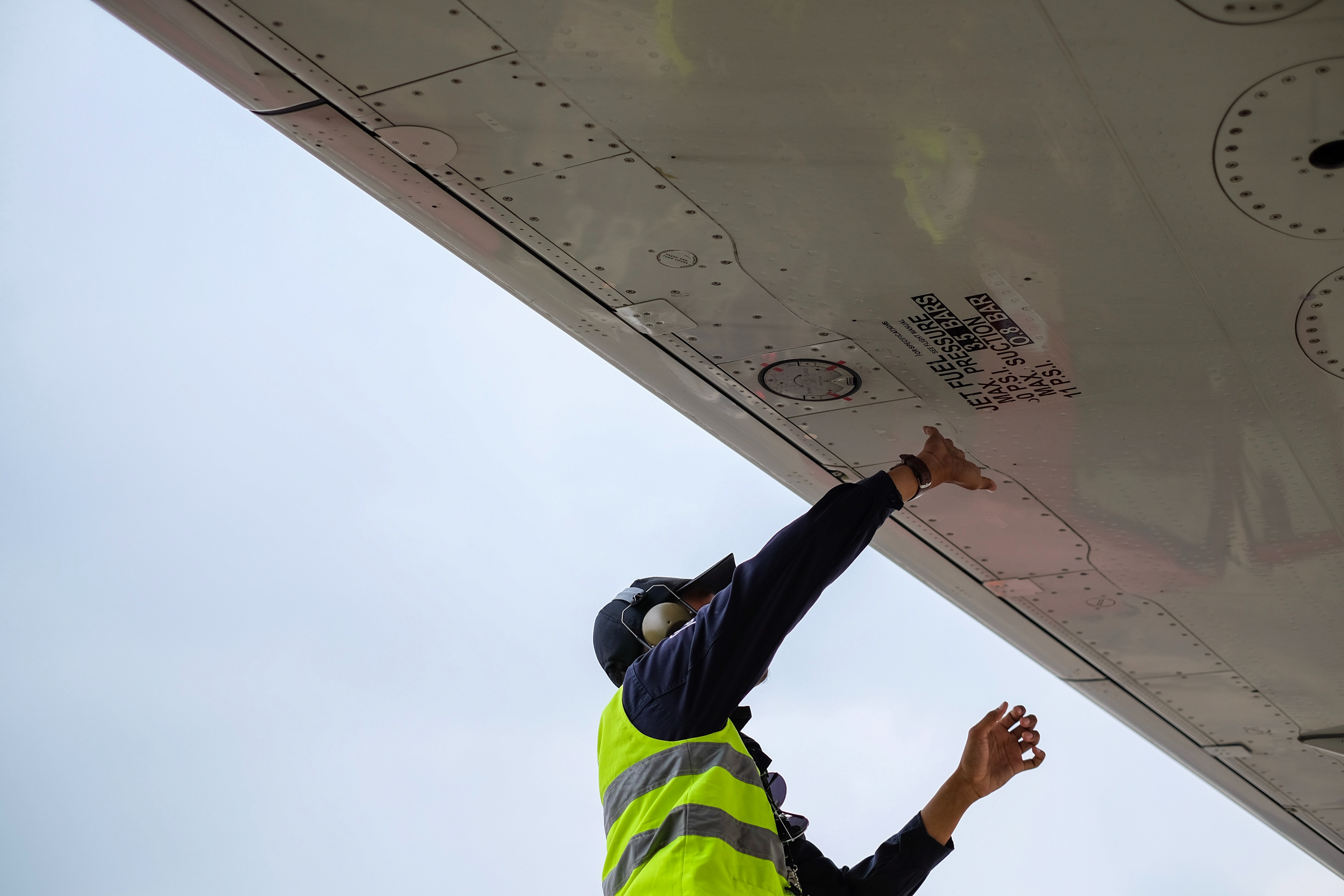 Man under an airplane wing